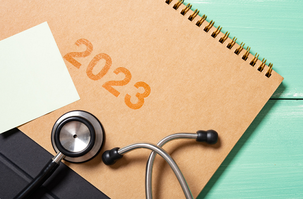 the year 2023 written on a notebook cover with a stethoscope next to it