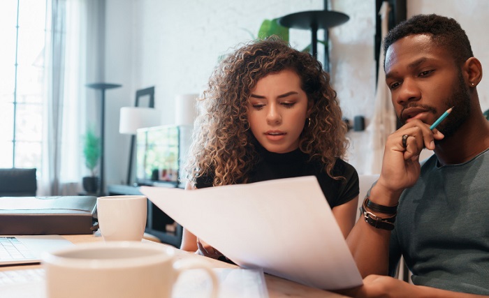 man and a woman analyzing finances