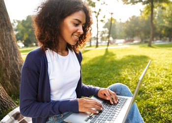 Female Student on Laptop Outdoors