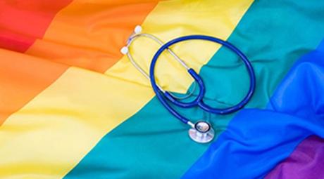 A stethoscope on top of a rainbow flag