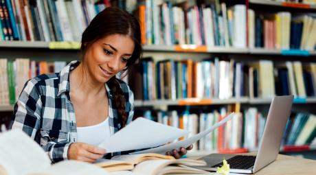 A student reads documents in a library