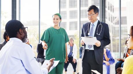 diverse people listening to the doctor's presentation
