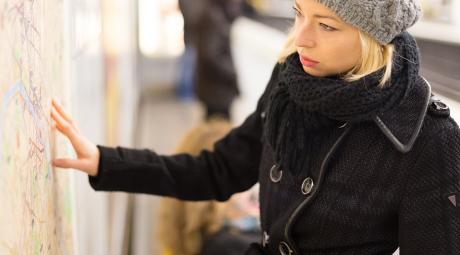 Lady looking on public transport map panel