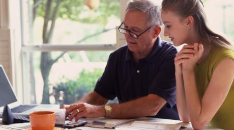 Parent and student looking at a laptop together