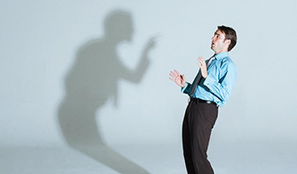 An illustration of a person being scolded by their shadow