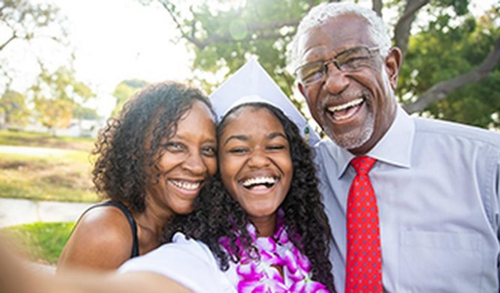 A student and parents celebrate graduation