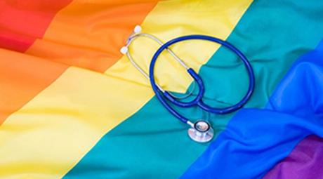 A stethoscope on top of a rainbow flag