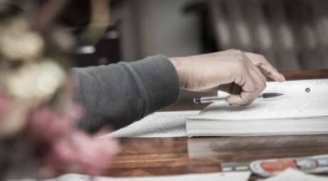 Image of student with pen and notepad.