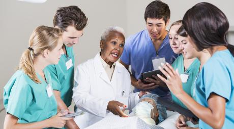 Medical students training with the doctor.