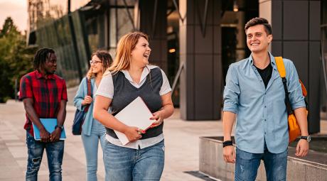 A group of students walk across a campus