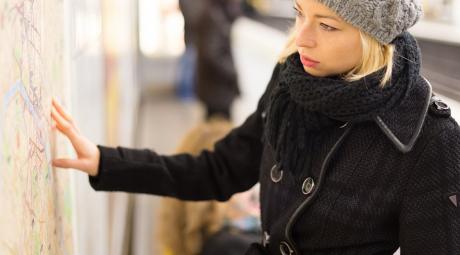Lady looking on public transport map panel