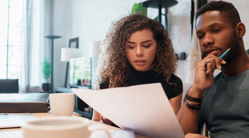 man and a woman analyzing finances