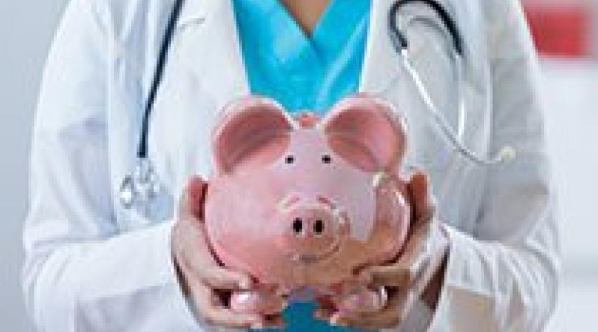 A doctor holding a piggy bank